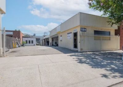 a yellow mechanic garage with a large courtyard