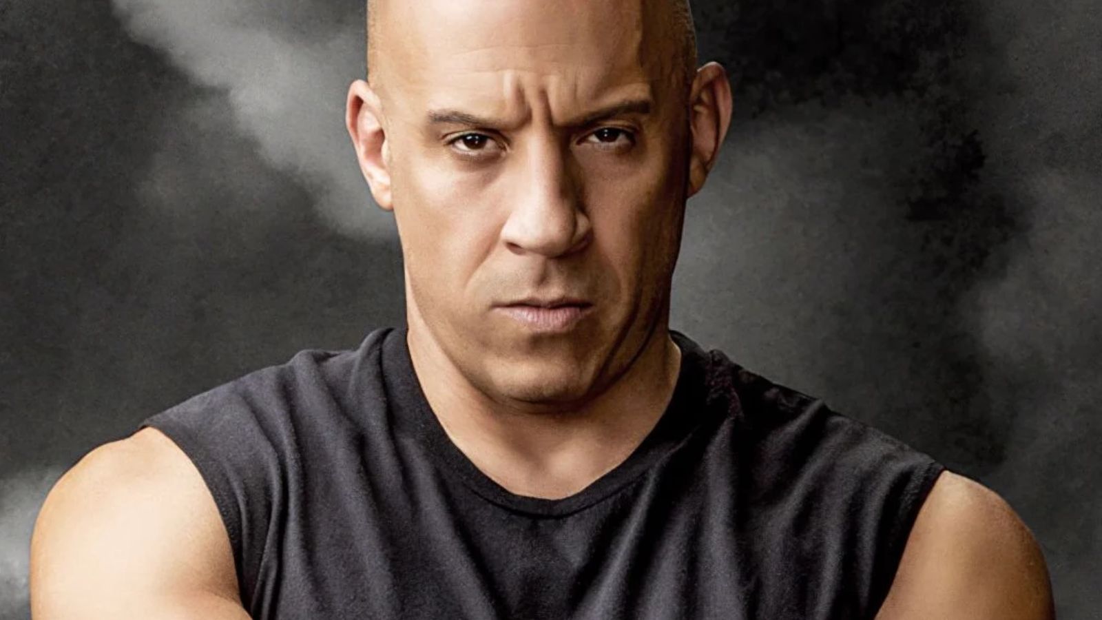 a bald man with olive skin tone wearing a tank top.