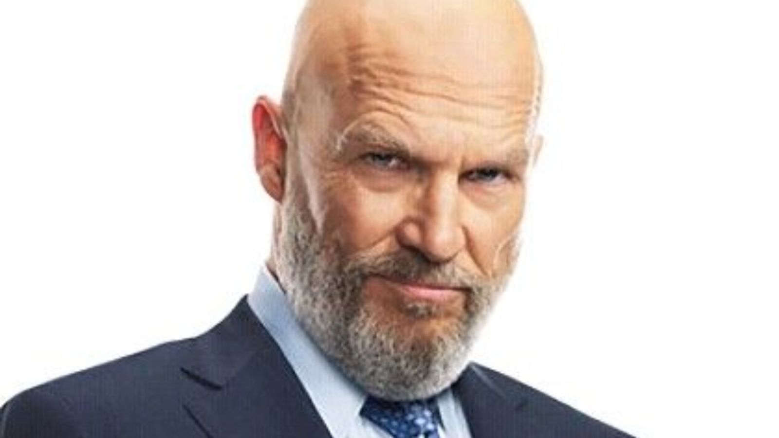 An older bald white man in a tailored suit Obadiah Stane