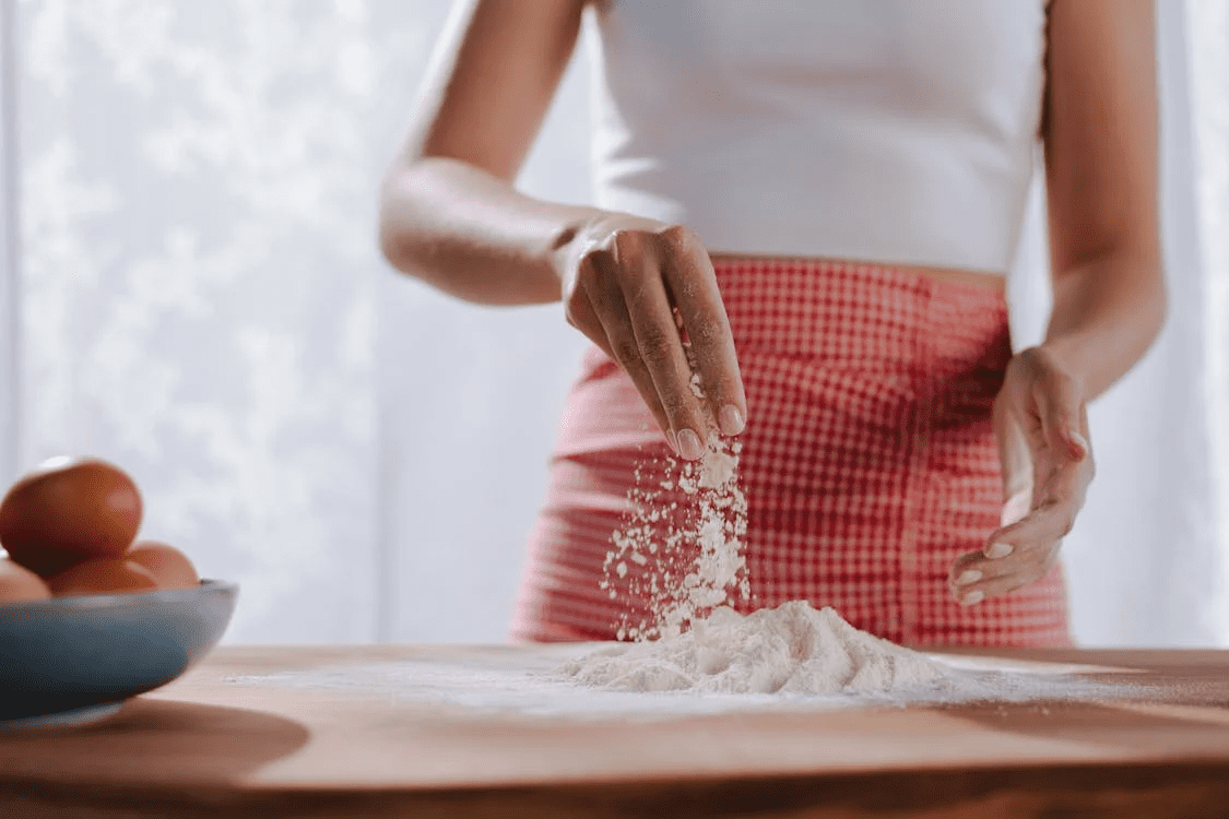 Chapter 3: Dinner For Two An image of a woman baking with flour.