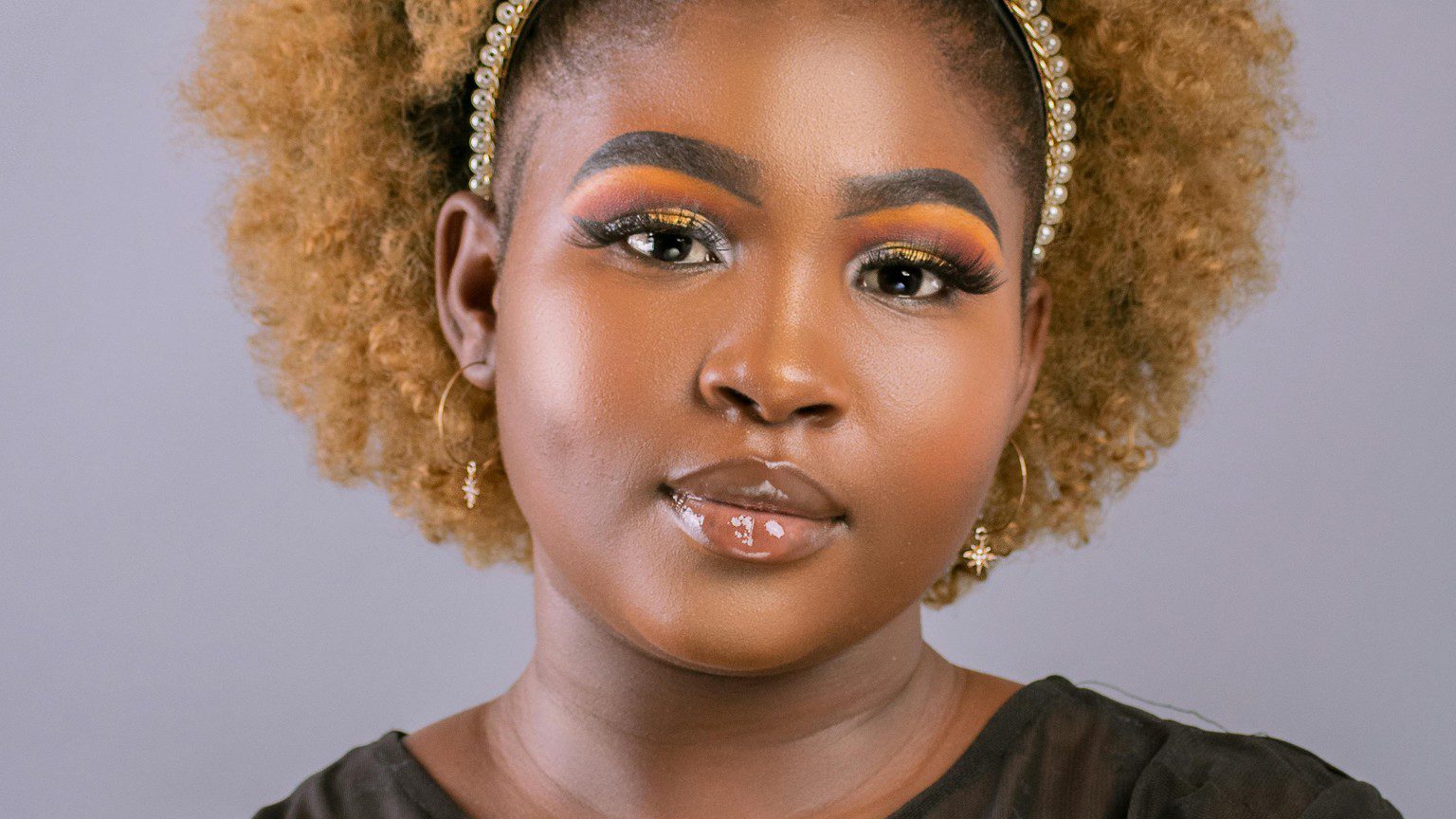 a photo of a beautiful plus size dark skin Black woman with a blonde afro.