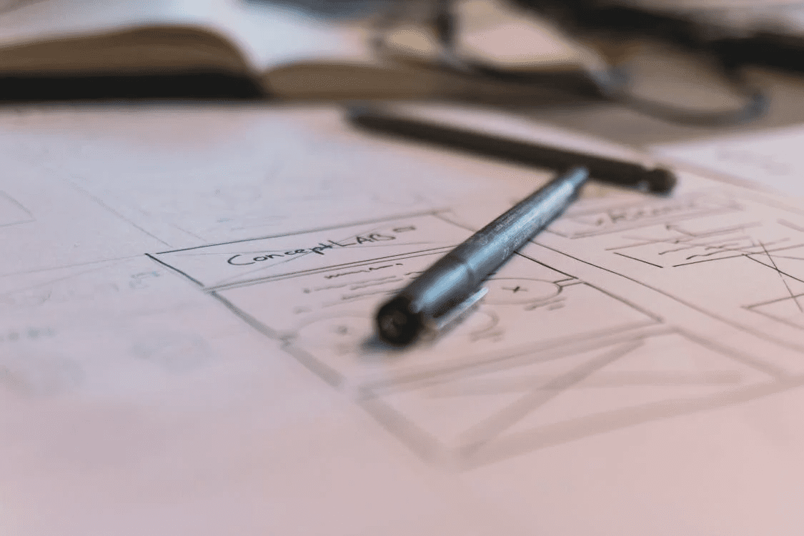 lines in the sand a pencil laying on top of a blueprint