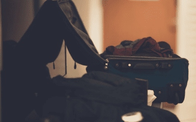 An image of open suitcases sitting on the floor.