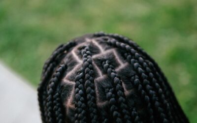 A cropped photo of the top of a Black woman's braided hair.