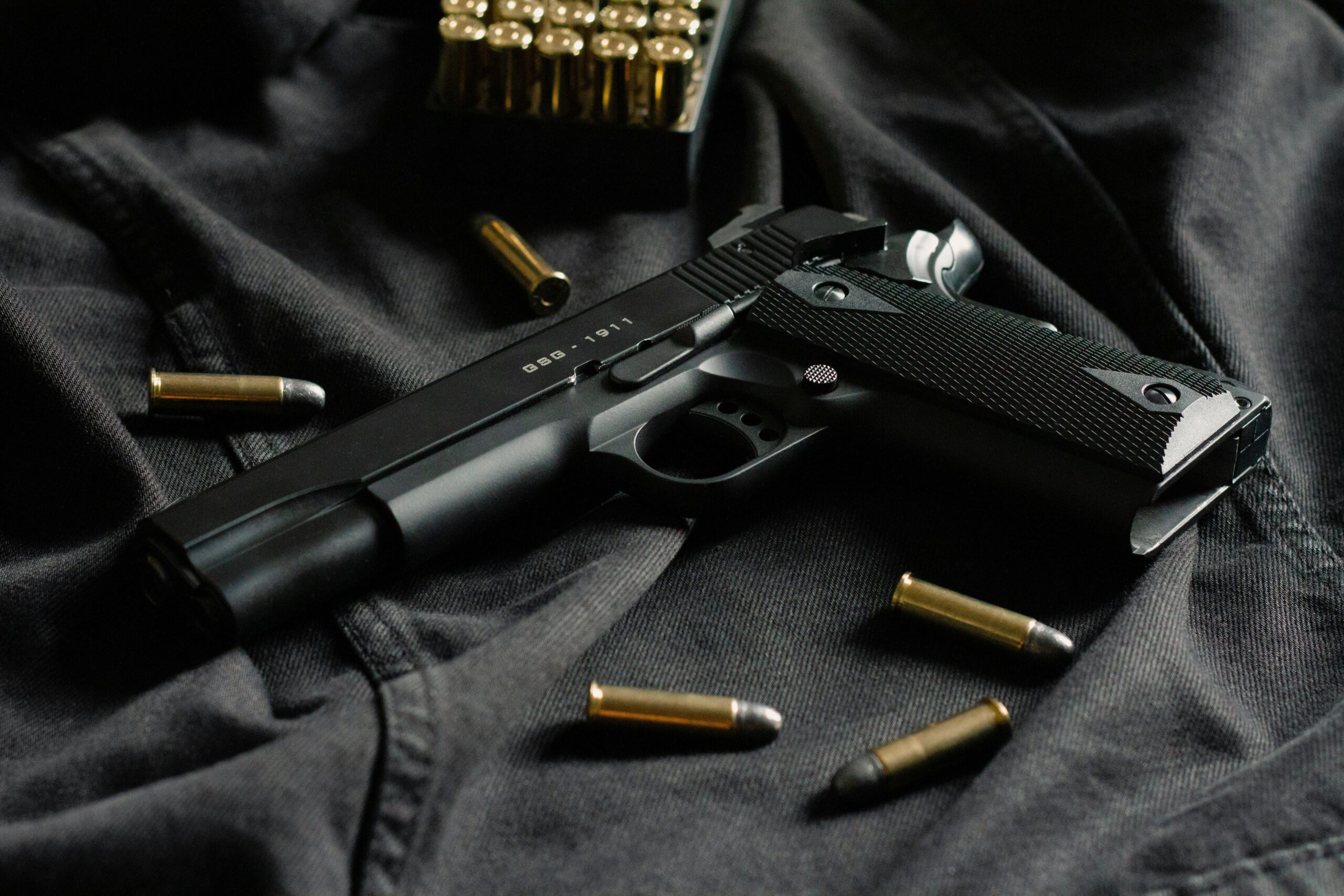 have gun will travel an image of a gun and bullets on a silk fabric background